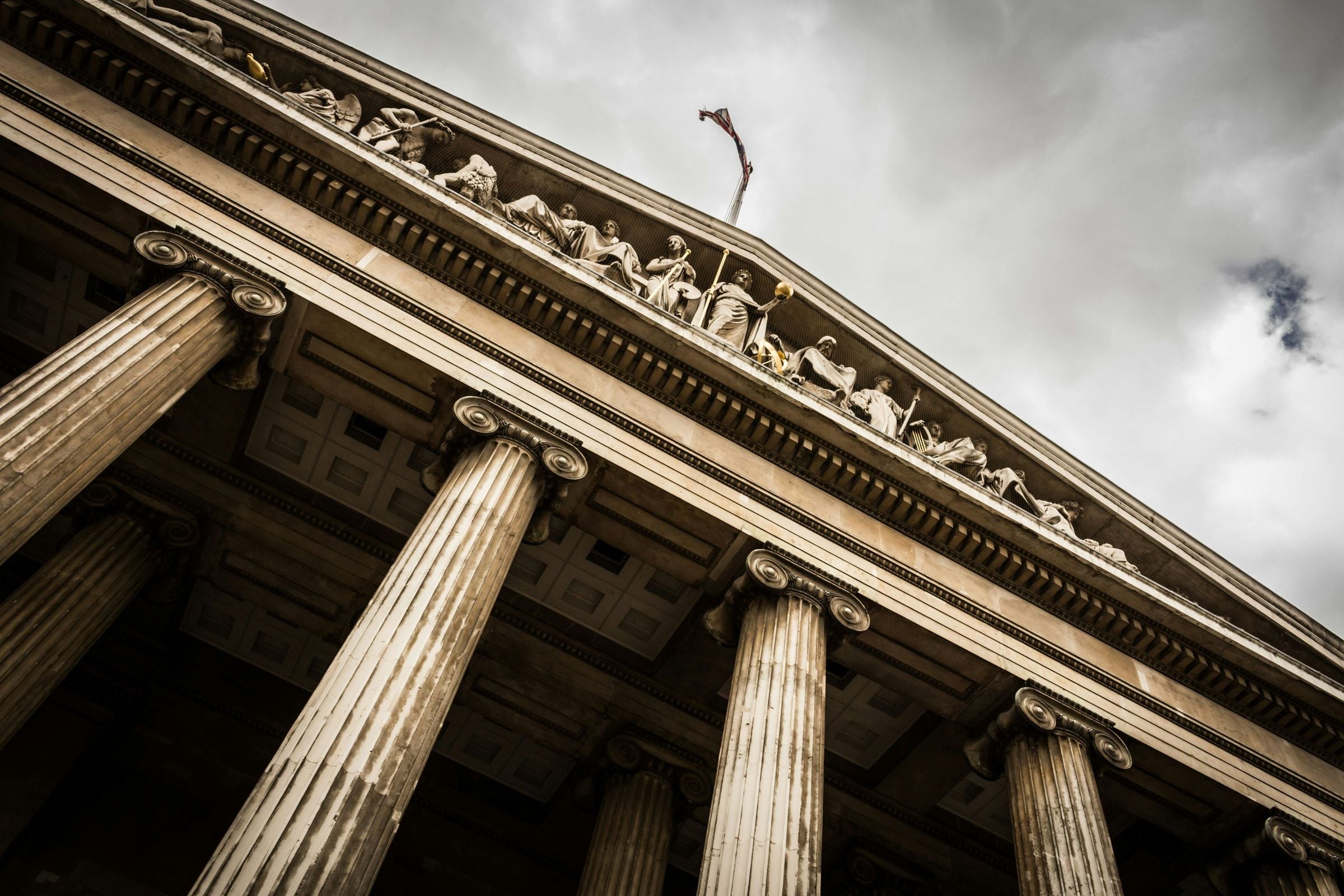 The columns and pediment of a classical bank building.