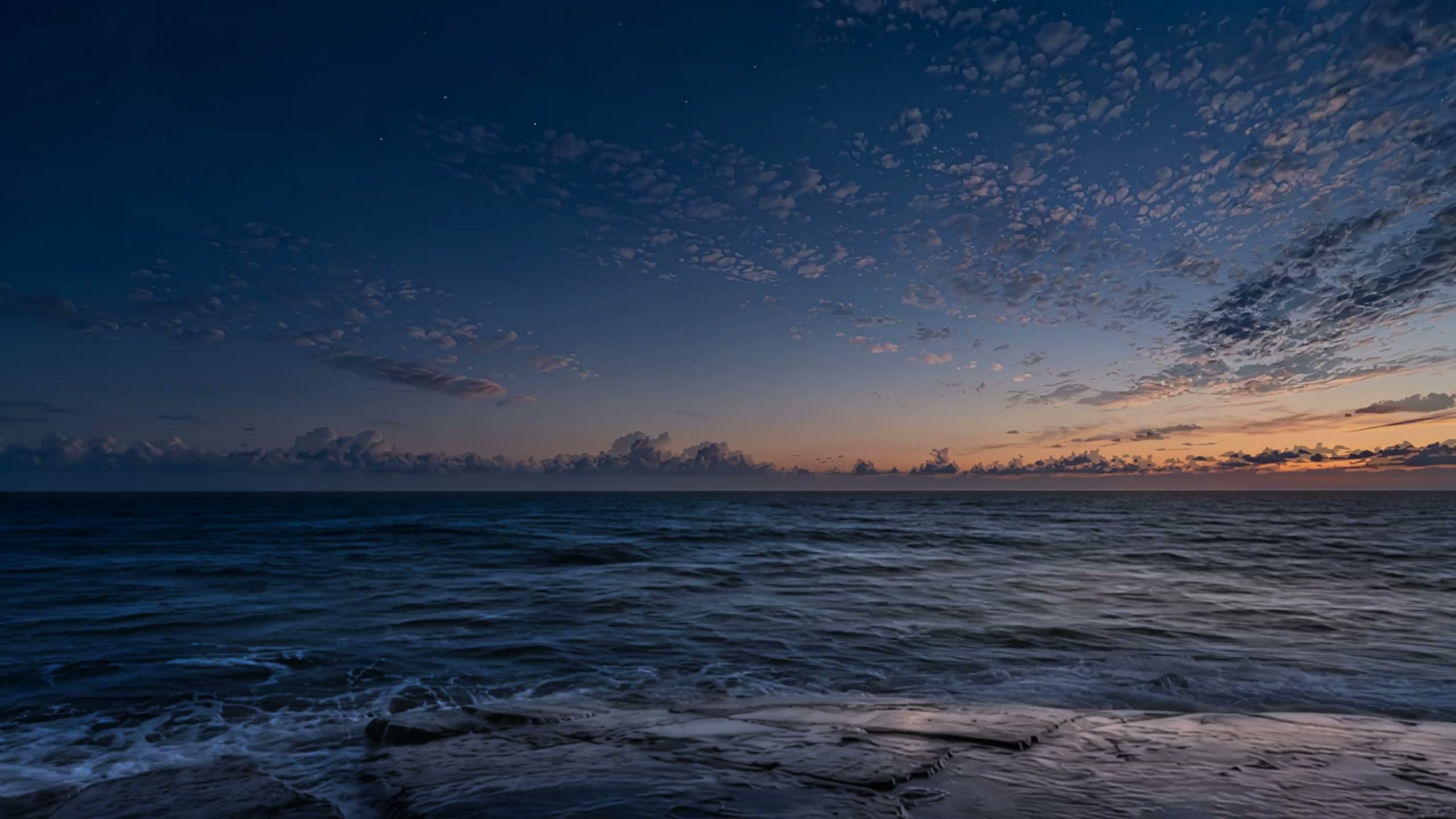 The open sea from a flat stone shore, from a deep blue night through sunrise to a bright, sunny day, and back through sunset.